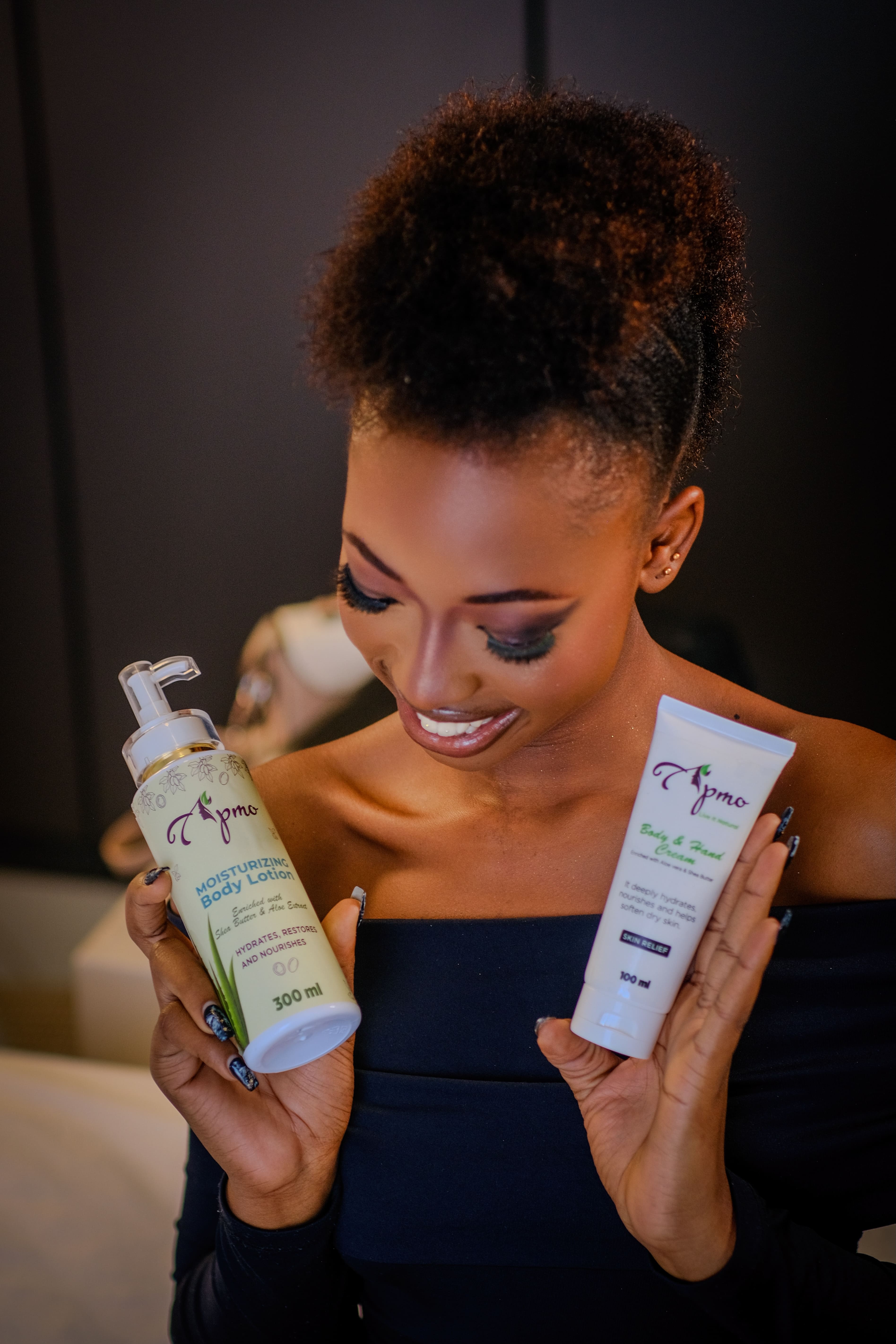 Apmo body lotion held by a model